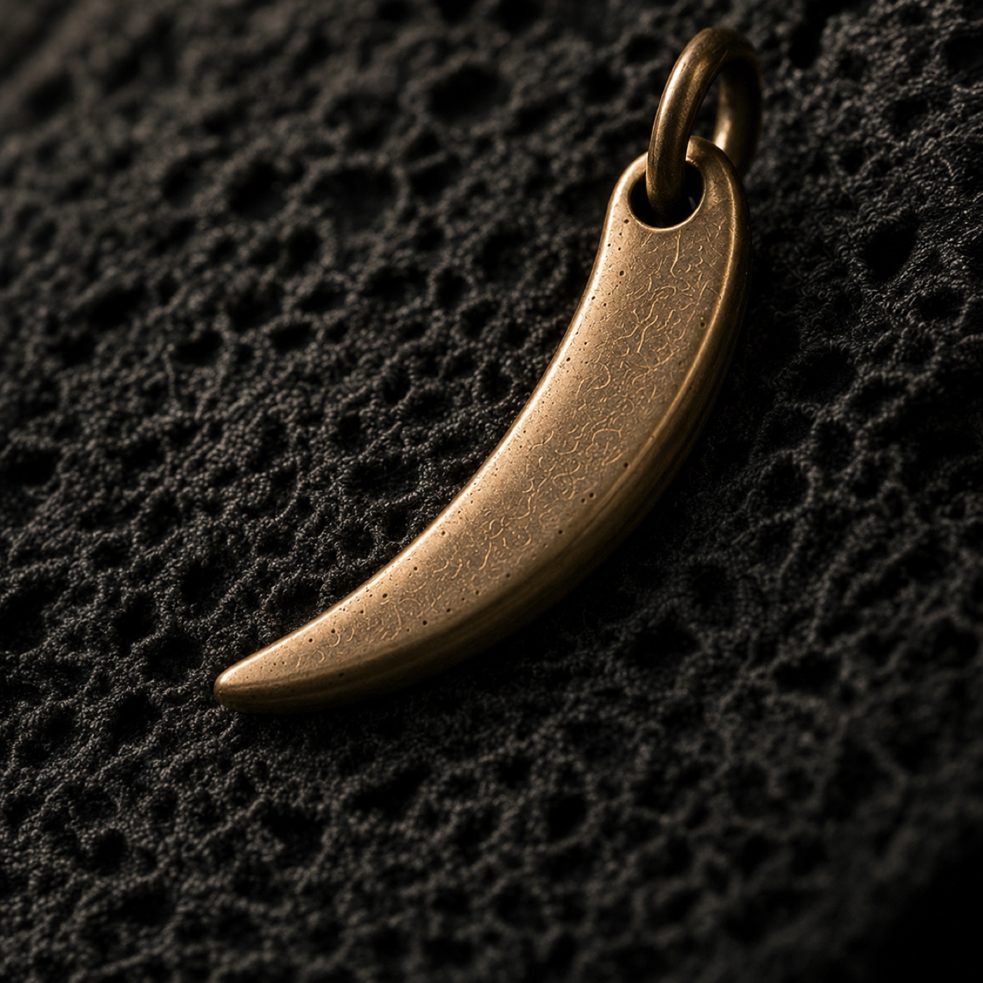 Macro detail of textured handcrafted brass jewelry by Farika Istanbul