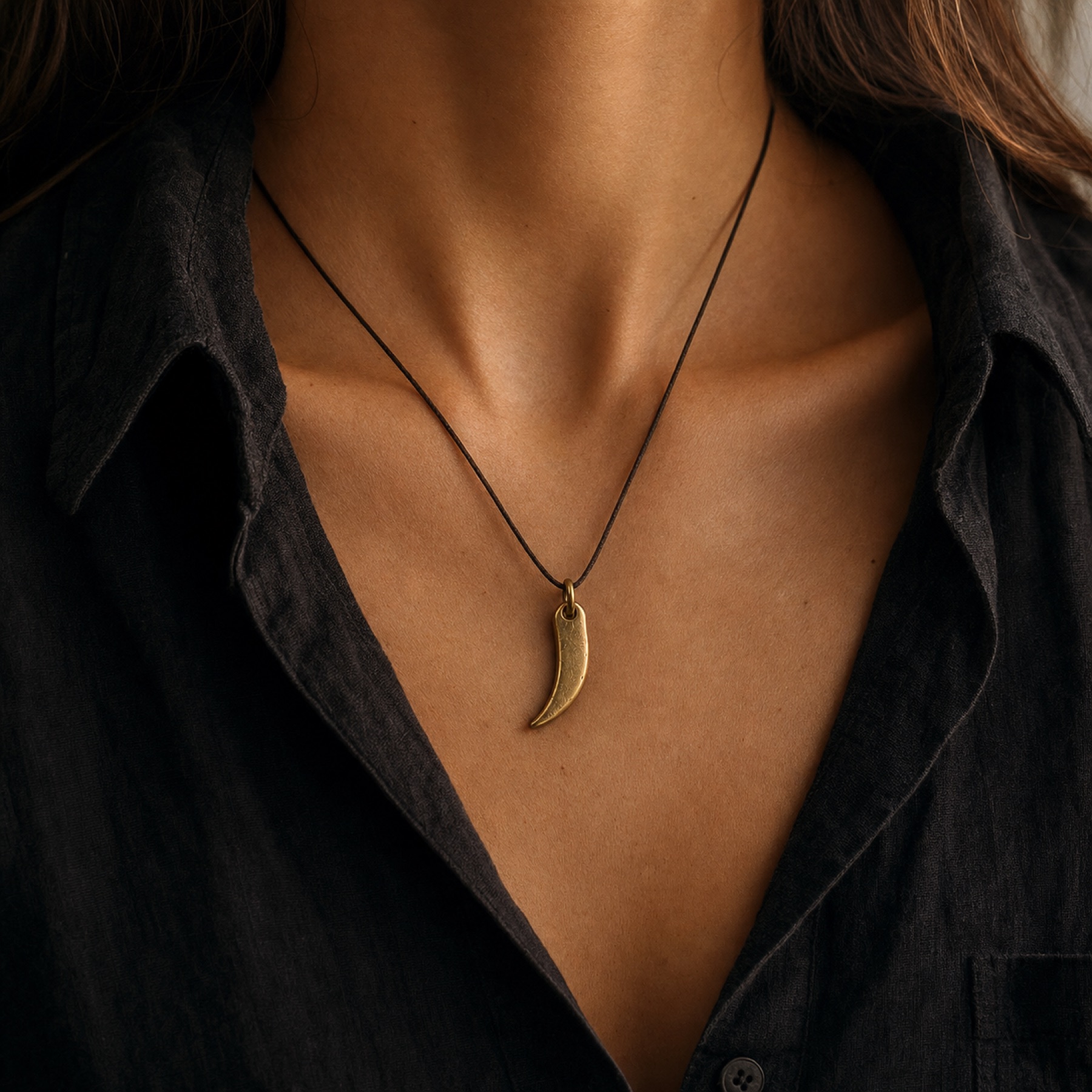 Sculptural brass pendant necklace by Farika Istanbul worn in editorial light